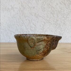 Rustic small browns with green hand thrown bowl with colander spout.